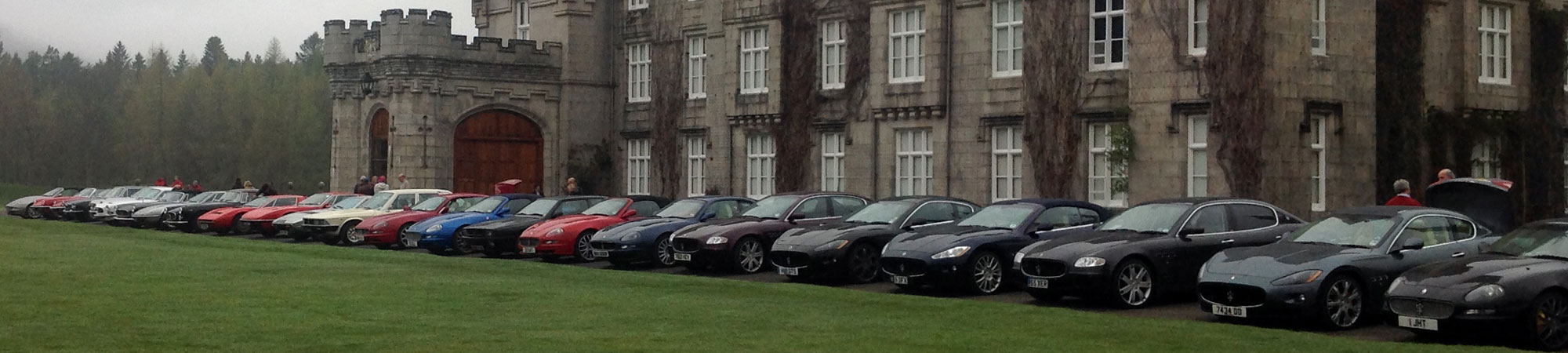 Row of Maserati cars at period building near Manchester